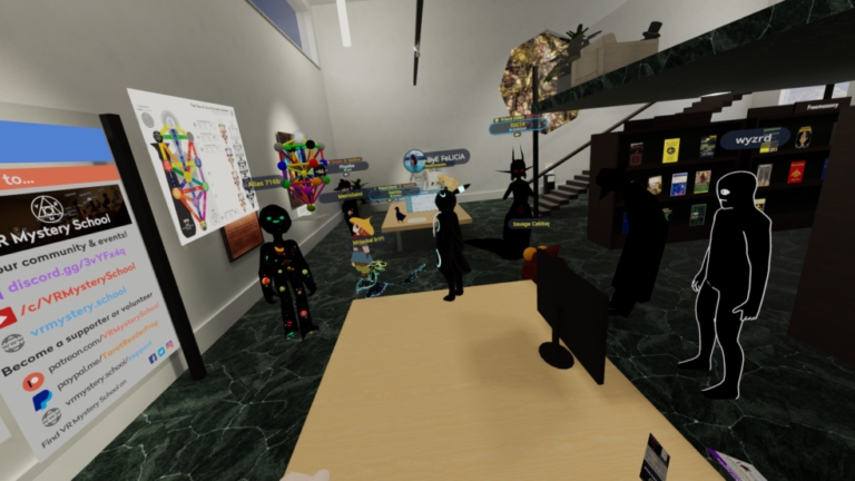 A VR Mystery School room in VRChat with displays and seating.